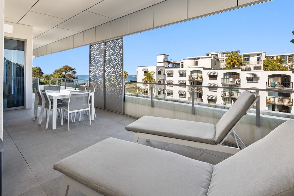 Elysee 3 Bedroom Apartment balcony with outdoor dining and sun lounges