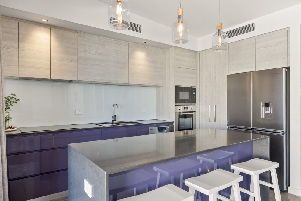 Elysee 3 Bedroom Apartment kitchen has this island spacious bench and seating area