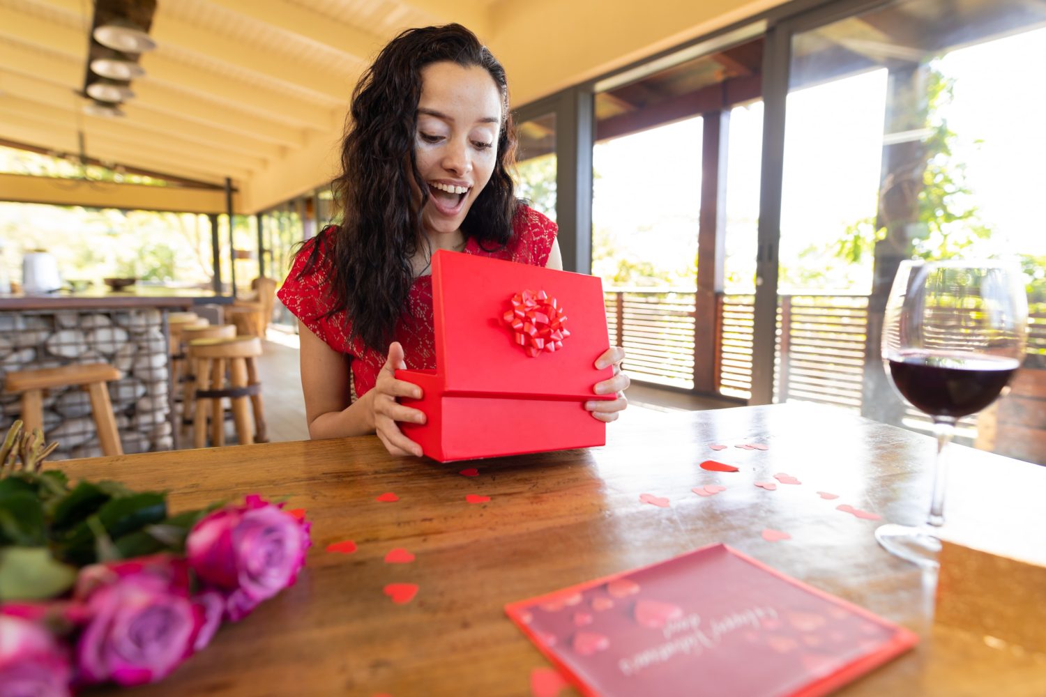 Person opening a gift with a surprised look