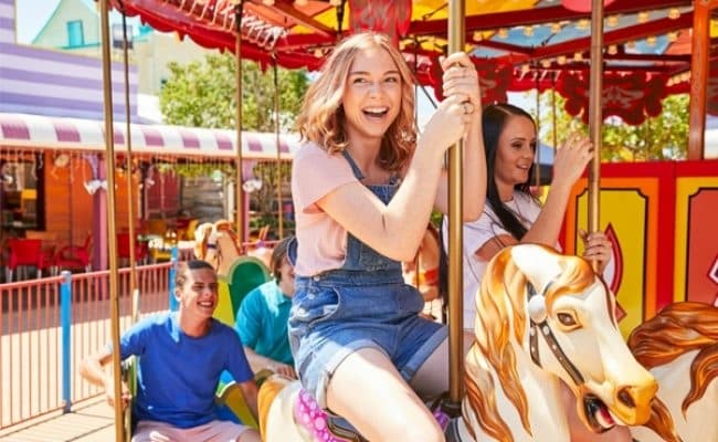 Kid riding carousel in Aussie World